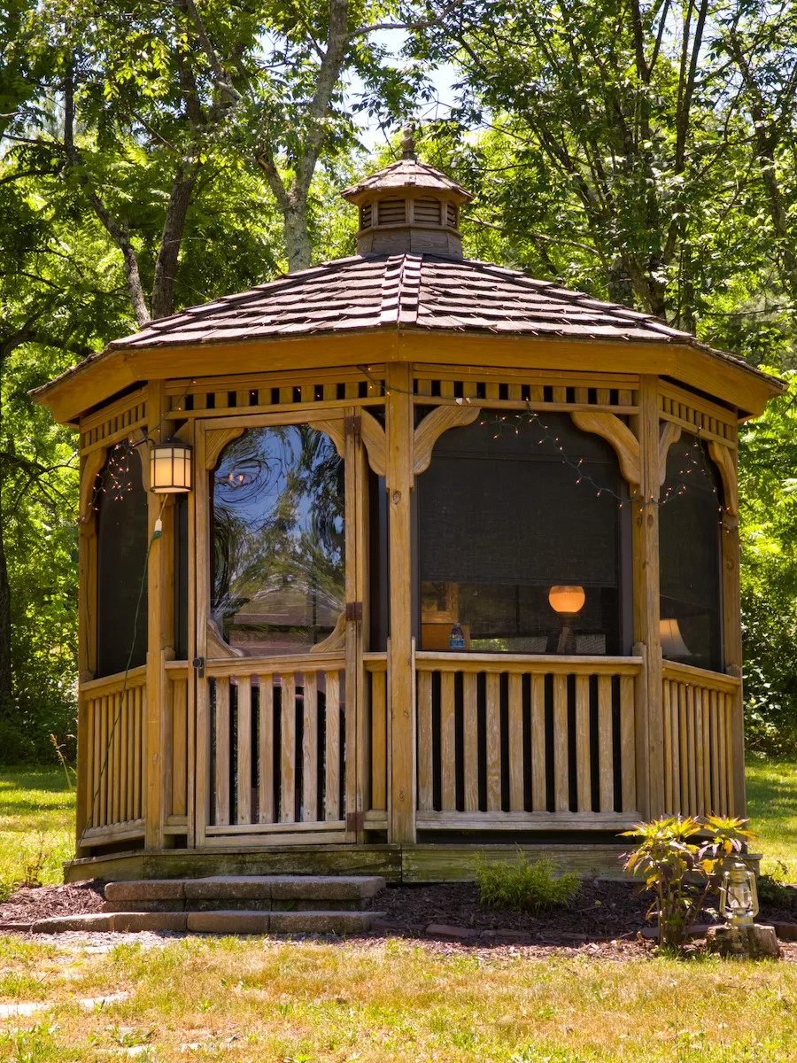 The screened Groom's Gazebo, lantern lit at the door