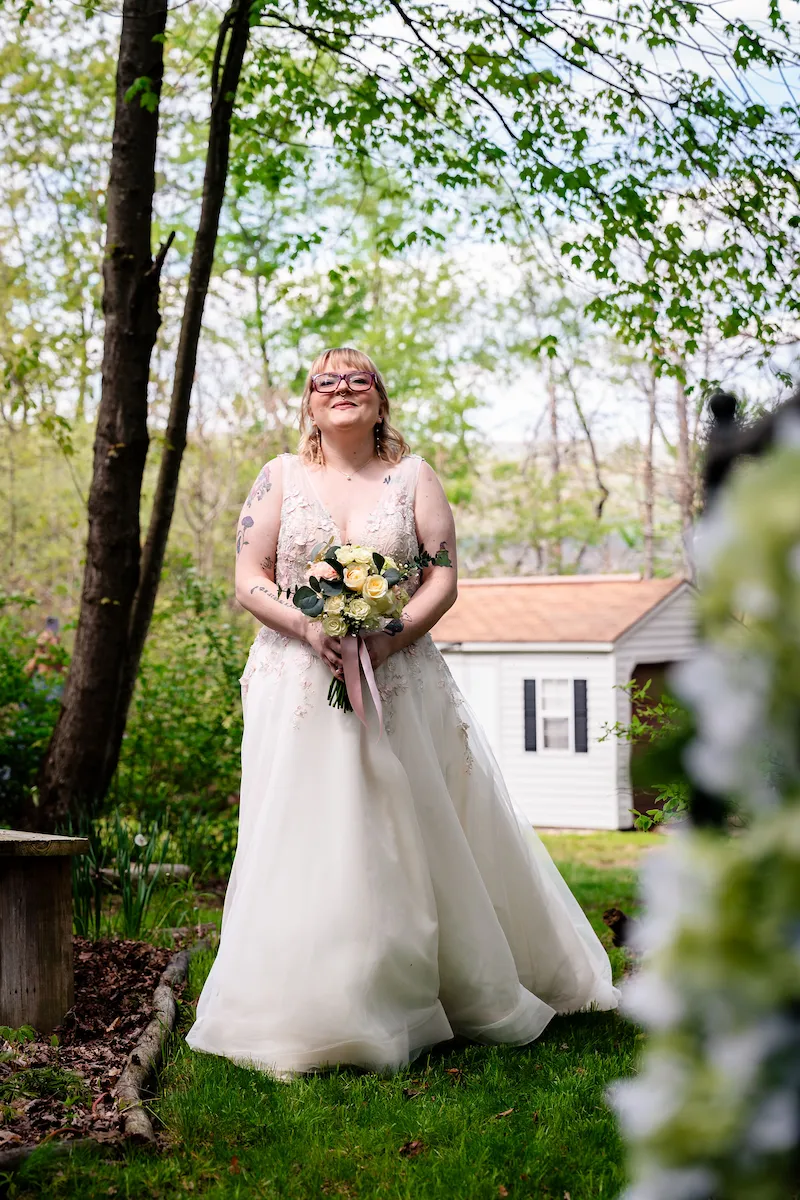 Tera outside the Bridal Suite in her gown, holding her bouquet