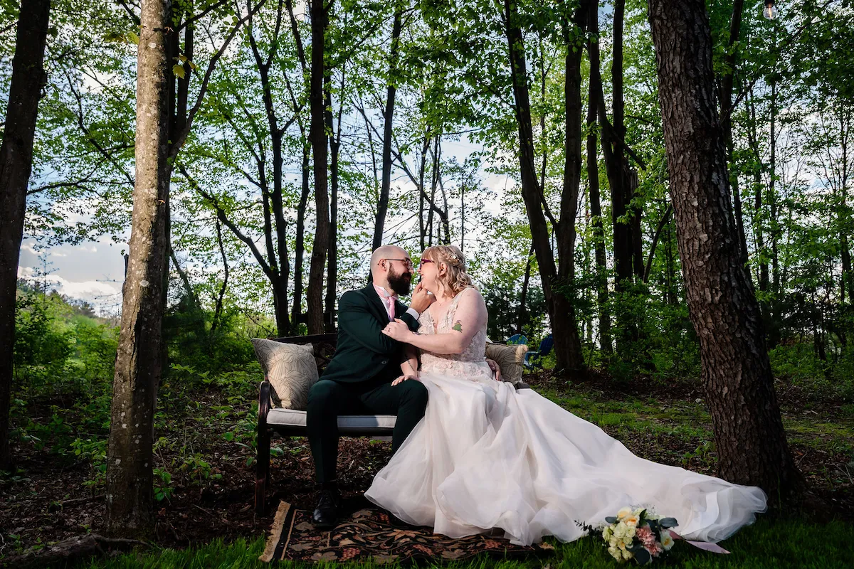 Tera and Matt kiss at the chapel altar in the spring sunlight