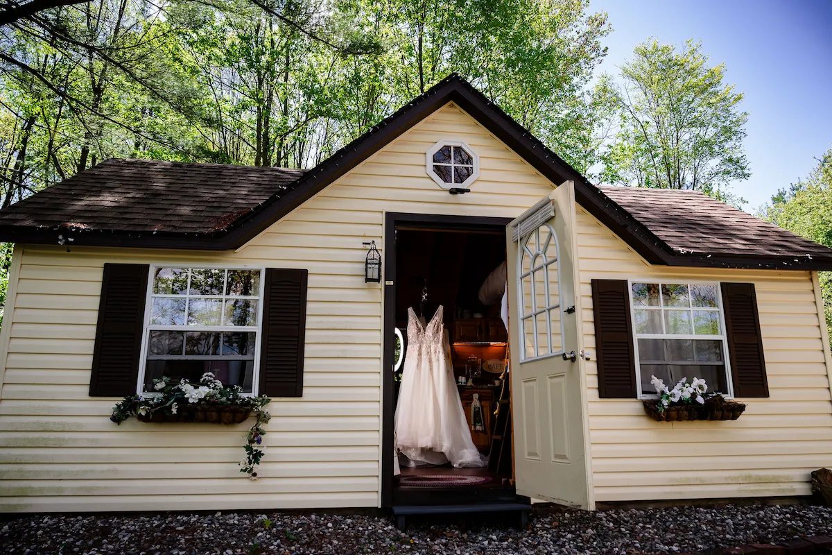 Tera's gown hanging in the doorway of the Bridal Suite cottage